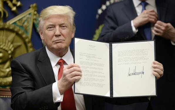 SIGNED, SEALED, DELIVERED: US President Donald Trump signs an executive order.