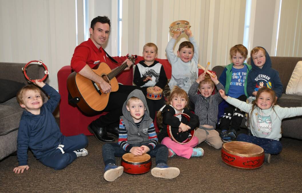 ON SONG: Robert Cleary entertaining some youngsters at Waratah Early Learning Centre. Photo: CARLA FREEDMAN