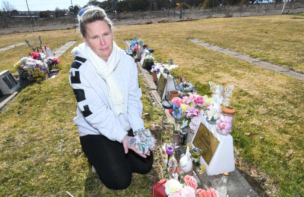 GRIEVING: Julie Dittmar beside her daughter Hayley Louise's grave, which was vandalised over the weekend. Photo: CARLA FREEDMAN