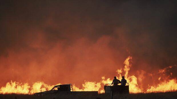 RED HOT: Farmers battle a fire near Cassilis. Photo: NICK MOIR