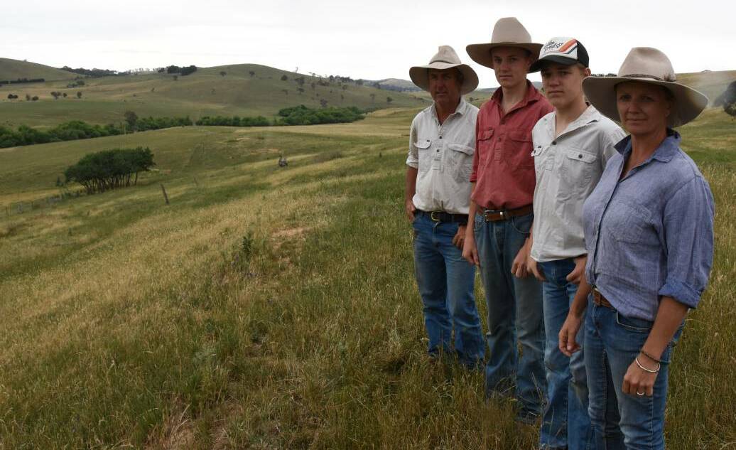 FAMILY AFFAIR: Dub, Lachlan, Harry and Rebecca Price stand near the gateway of their property. The treeline below is the Belubula River tracking through 'Weemala'.