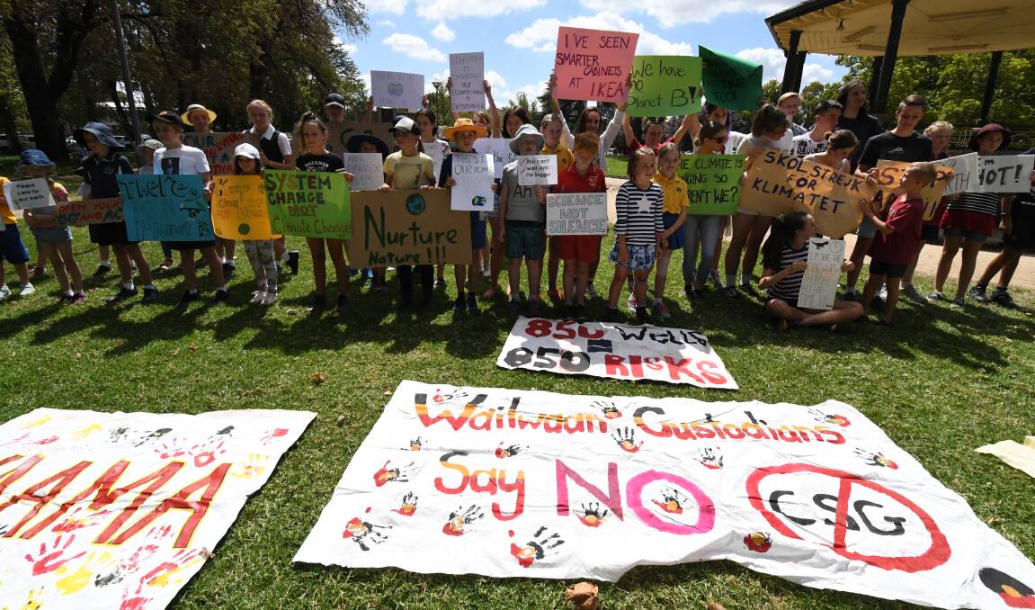 HEAR (AND READ) OR WORDS: The students protesting in Robertson Park. Photo: JUDE KEOGH