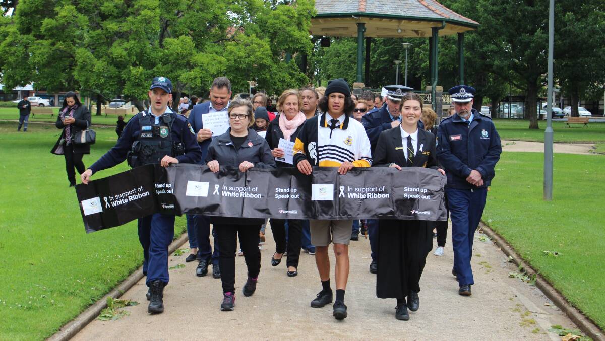 MARCHING FORWARD: Senior Constable Granton Smith, Penny Dordoy and Cain Selwood and Lucy Johnston lead the White Ribbon Day march in Orange. 