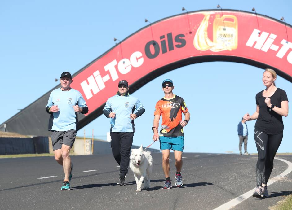 TICK ANOTHER ONE OFF: Orange-based police officer Phil Mounce-Stephens (left) and his support runners complete another circuit of Mount Panorama during his 24-hour effort in the name of Police Legacy over the weekend.