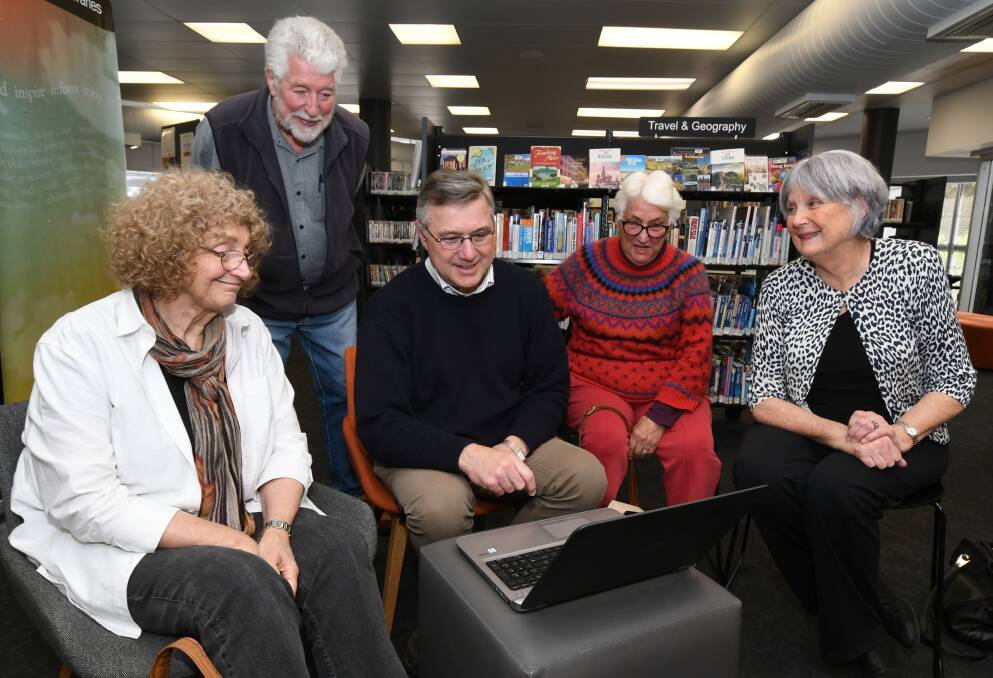 LOOKING BACK: Dr Tim McAnulty (centre), sharing his expereinces during the Nyngan flood of 1990 with Orange Oral History group members Lesley Melville, John Coxhill, Monica Knight and Rhyl Martin. Photo: JUDE KEOGH