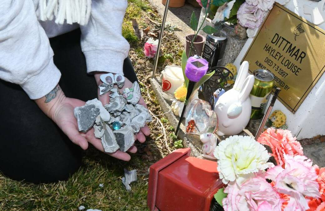 WHAT REMAINS: Julie Dittmar with the broewkn keepsakes she and her family and friends had left by her daughtert's graveside. Photo: CARLA FREEDMAN