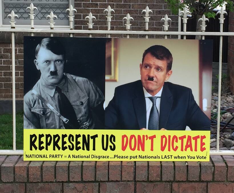 EXTREME POSITION: One of the controversial election campaign posters which have been fixed to the front fence of a McLachlan Street home. Photo: JUDE KEOGH
