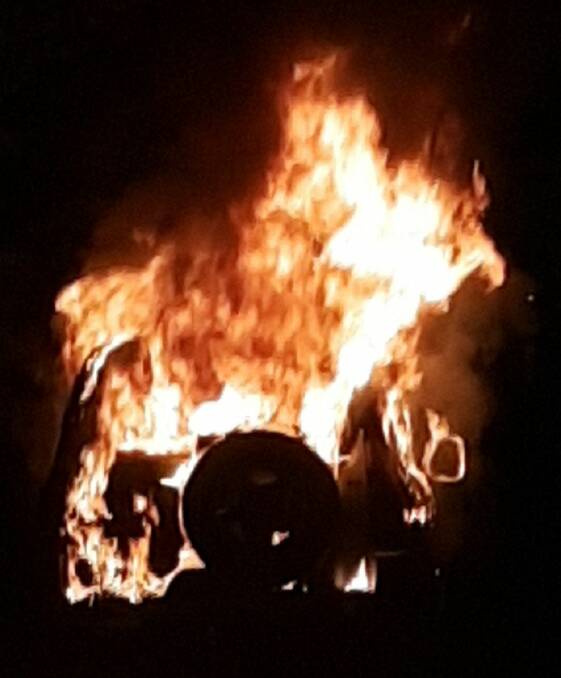 ALIGHT: The blazing car on Lone Pine Avenue. Photo: SARAH SHEARGOLD