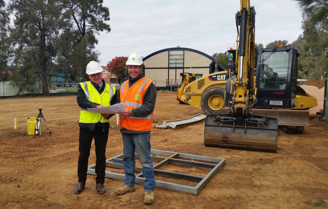 UNDER WAY:  Cabonne’s Council community engagement and development manager Dale Jones (left) and site foreman Miles Wright on the site of the new fossil storage facility being built at the Age of Fishes Museum in Canowindra. Photo: CONTRIBUTED