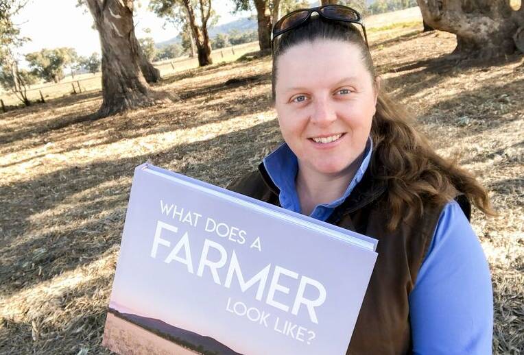 SEE FOR YOURSELF: Kim Storey with a copy of her book ‘What does a farmer look like?’. Photo: SUPPLIED