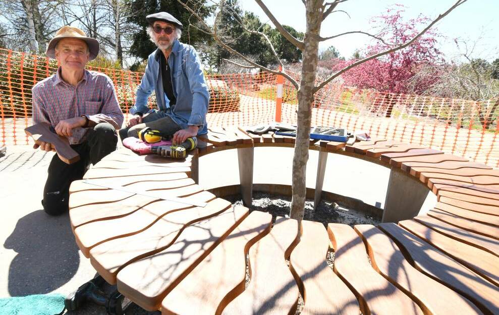 GORGEOUS CREATION: Geoff Tonkin and Tim Winters with the seat they have designed and built for the gardens' 30th anniversary. Photo: JUDE KEOGH 0927jkgardens2