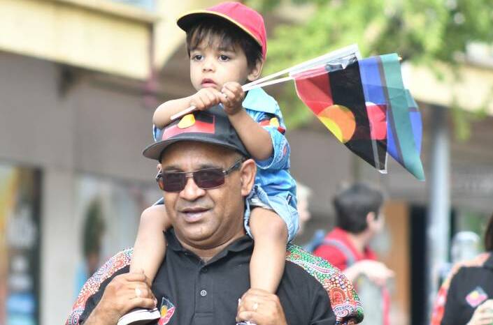 PROUD: Wade and Ronald Ebsworth in last year's NAIDOC Week march. Photo: JUDE KEOGH