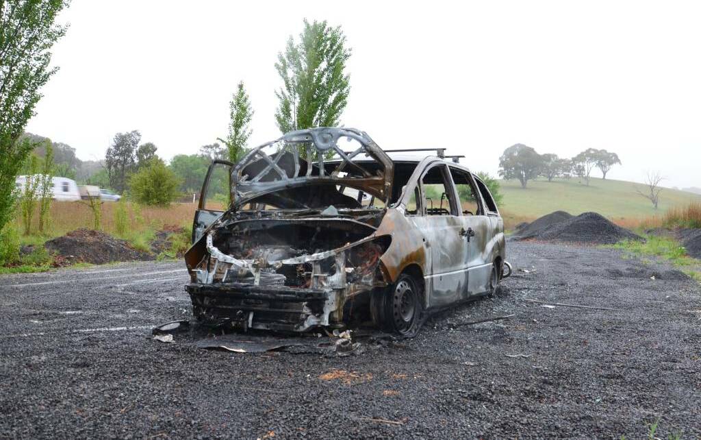 UP IN SMOKE: The wreck of a Toyota Tarago on Mitchell Highway. Photo: DECLAN RURENGA