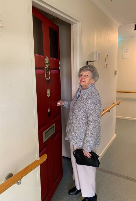 HOME AGAIN: St Francis Aged Care resident Rae Richards inspecting the customised, stick-on decal on the door to her residence. Photo: SUPPLIED 