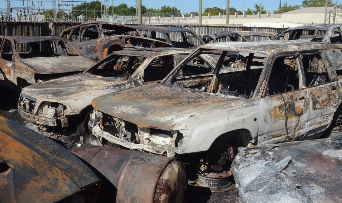 TOTAL DAMAGE: What remains of the holding yard of JG Auto Sales in William Street after Saturday's fire. Photo: DAVID FITZSIMONS