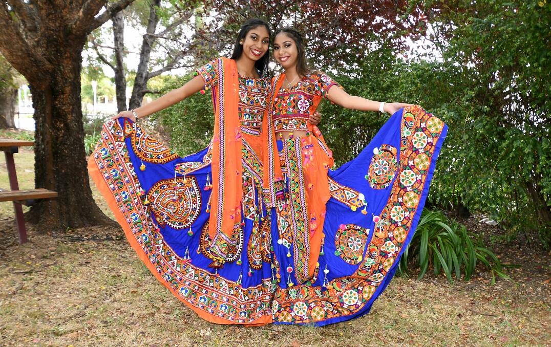 COLOURFUL TOUCHES: Sharolyn and Ashlyn Narayan showcasing the Bollywood theme which will feature at Saturday's Harmony Day celebrations. Photo: JUDE KEOGH