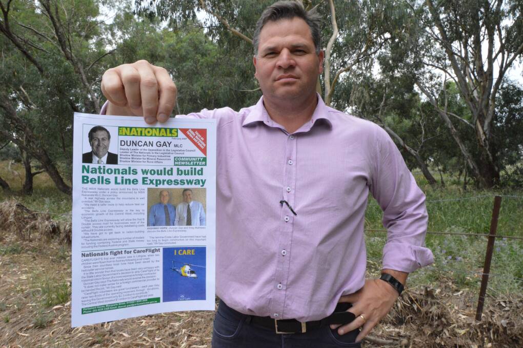 WHERE IS IT?: Member for Orange Phil Donato with a newsletter published in 2007 by Duncan Gay, pledging to build the Bells Line expressway.