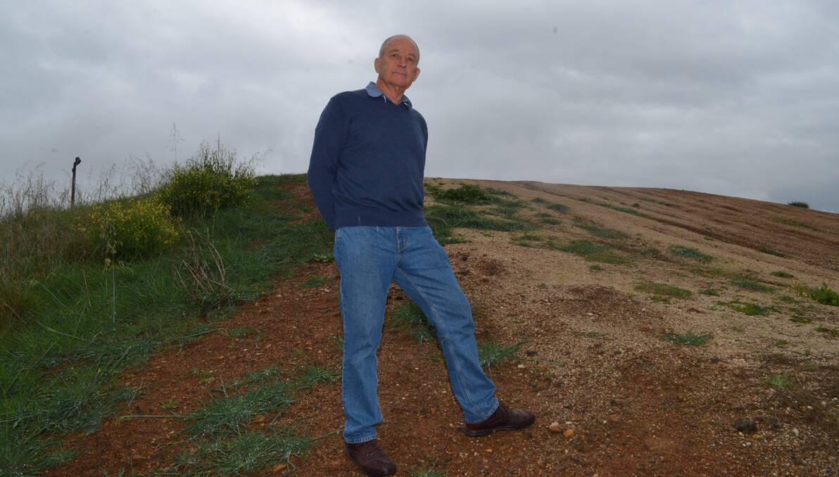 IN THE WEEDS: Councillor Russell Turner on the BMX track. Photo: DANIELLE CETINSKI