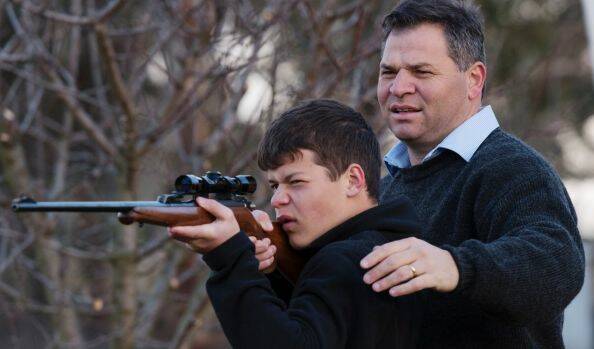 TAKING AIM AT CHANGE: Shooters, Fishers and Farmers Party member, Phil Donato with 13-year-old son Sean on their property outside Orange. Photo: JAMES BRICKWOOD