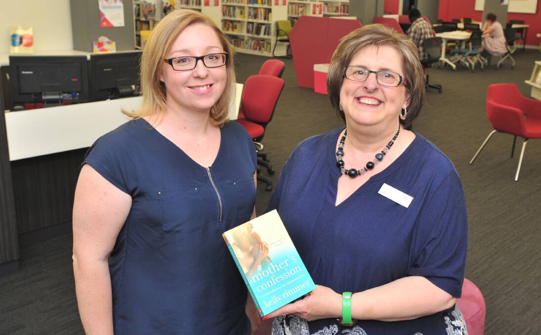 TALES TO TELL: Author Kelly Rimmer and customer service officer at Orange TAFE Judy Hansen prepare for Thursday evening's celebrations of Mrs Rimmer's new book. Photo: JUDE KEOGH 1129jkrimmer2