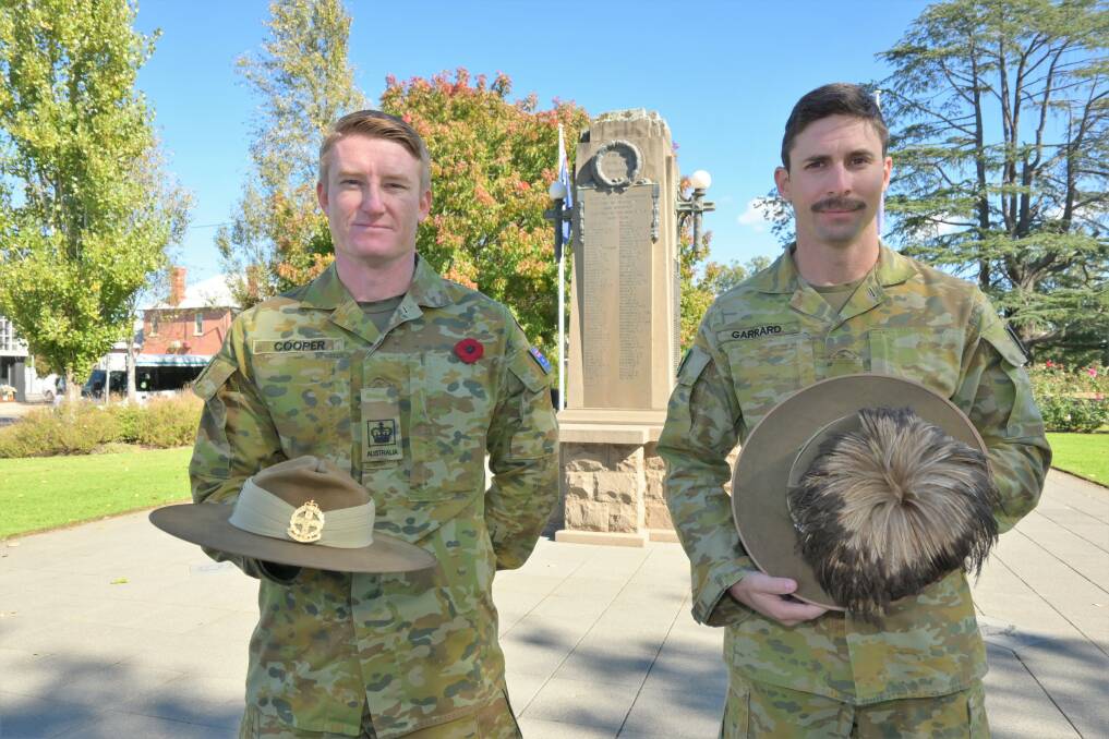 HERE TO SERVE: Warrant Officer Class Two Robert Cooper and Corporal Michael Garrard are keeping their family traditions alive. Picture: Kenji Sato