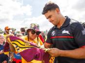 NRL star Latrell Mitchell signs a jersey for a fan at the launch of the Pathfinder project on Broughton Oval, Moree. Photo Simon Scott Photo