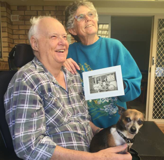Graham and Betty Frost with Toby the rescue dog and a photo of Graham's parents.