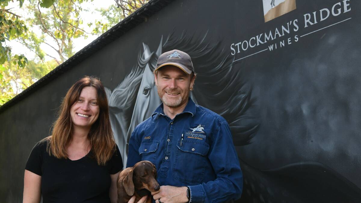 Lisa and John Hambrook with Peanuts out the front of Stockman's Ridge Wines sign. Picture by Carla Freedman