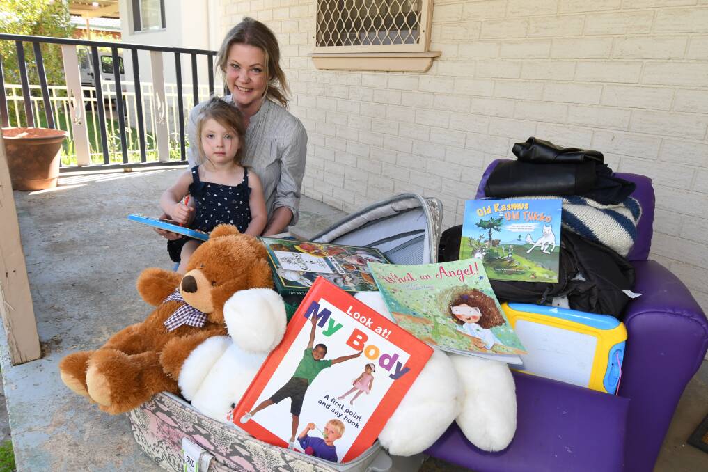 HELP TO TAREE: Emma and Freya Bradford with items ready to donate to the northern NSW bushfire victims. Photo: JUDE KEOGH