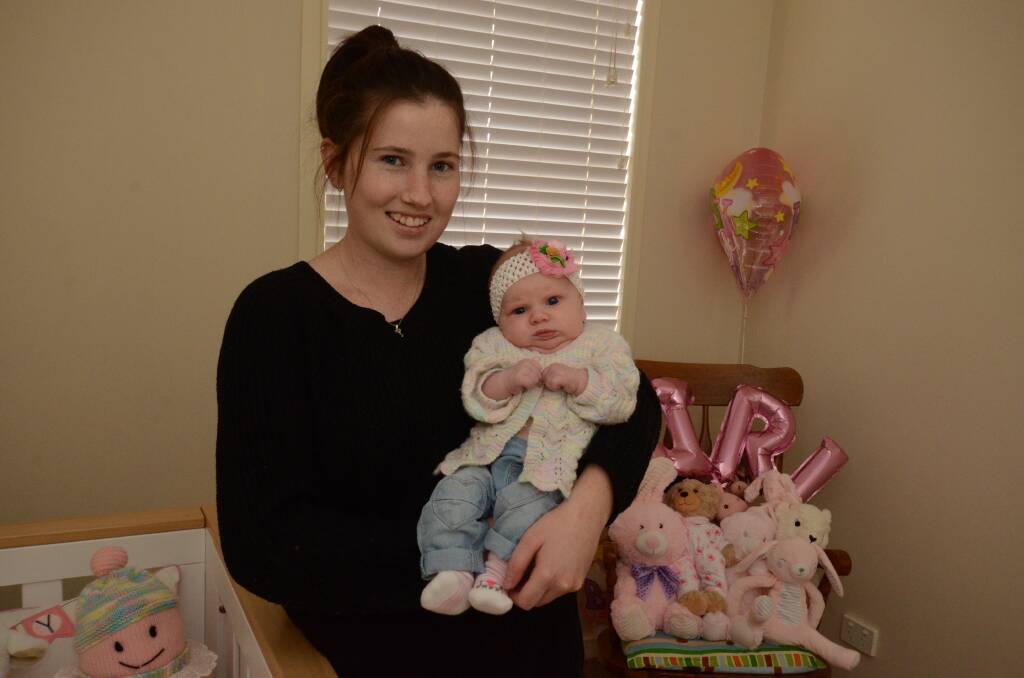 STARTING FAMILY EARLY: Olivia Lennard, pictured with seven week-old Skylah, says many women her age are having babies. Photo: JUDE KEOGH
