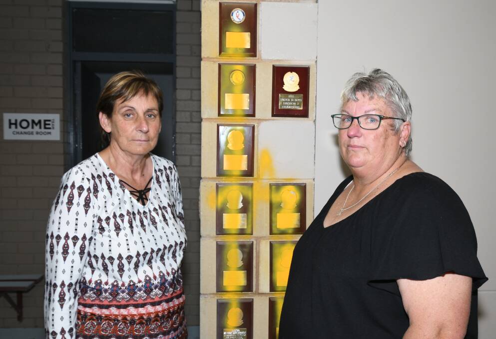 SAD LOSS:Orange Hockey Association's Marion Eslick and Michelle Stevenson with some of their destroyed trophies. Photo: CARLA FREEDMAN 1015cfvandal2