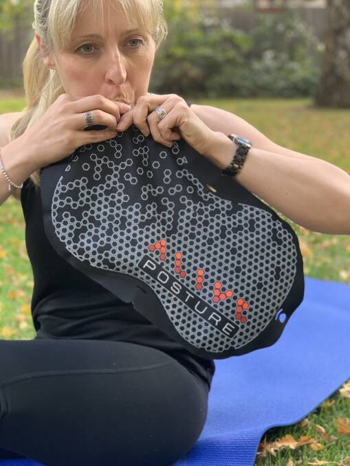 INVENTOR: Alive Health's Alison Bennett with the Posture M8. Photo: SUPPLIED