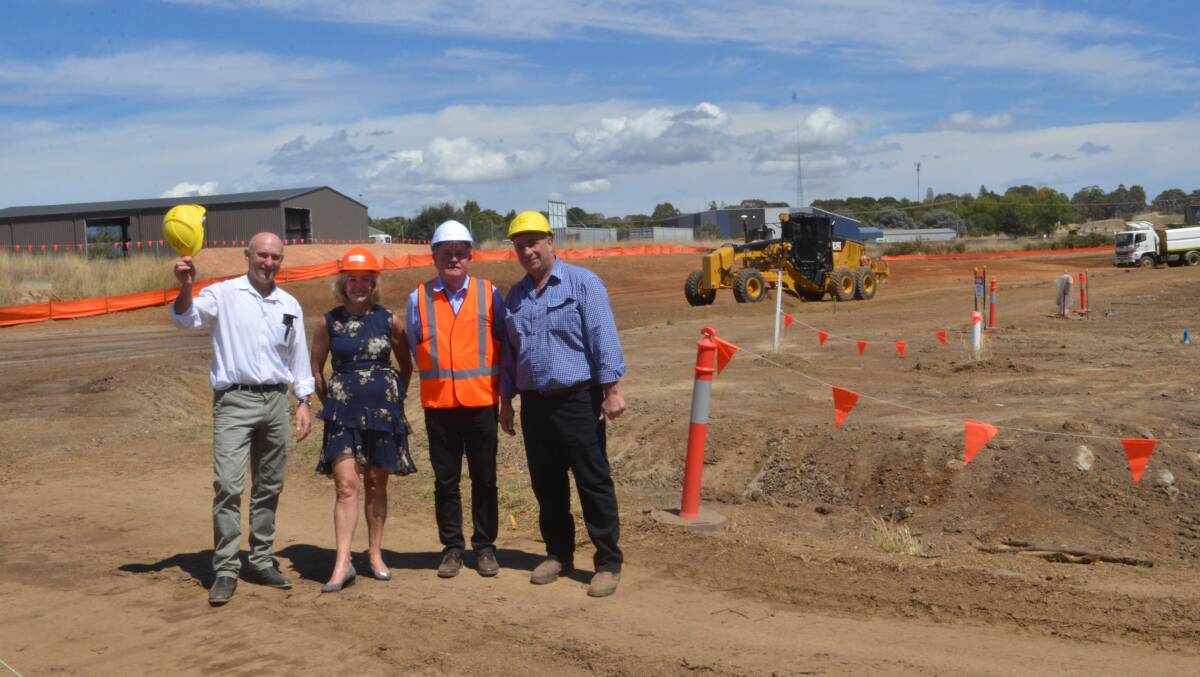 WORK PROGRESSING: Gladys and Colin Woods of Haslin Constructions (centre) with councillors Scott Munro and Sam Romano on the site of stage two of the southern feeder road, with the Forest Road intersection already just visible. Photo: DANIELLE CETINSKI
