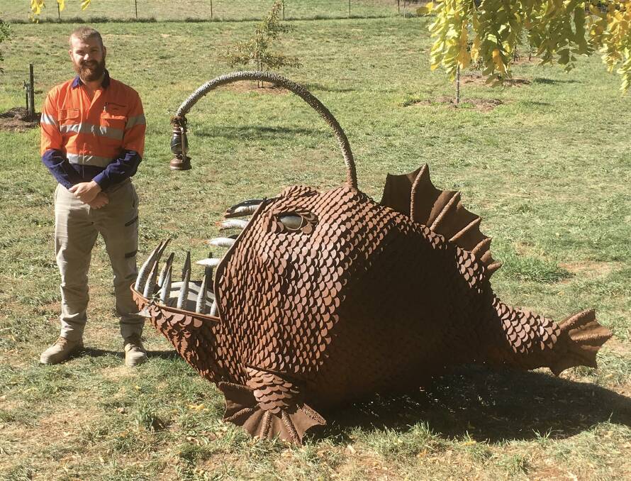 HEAVY HITTER: Luke Hort with his winning sculpture, A Bright Side of Death. Photo: SUPPLIED