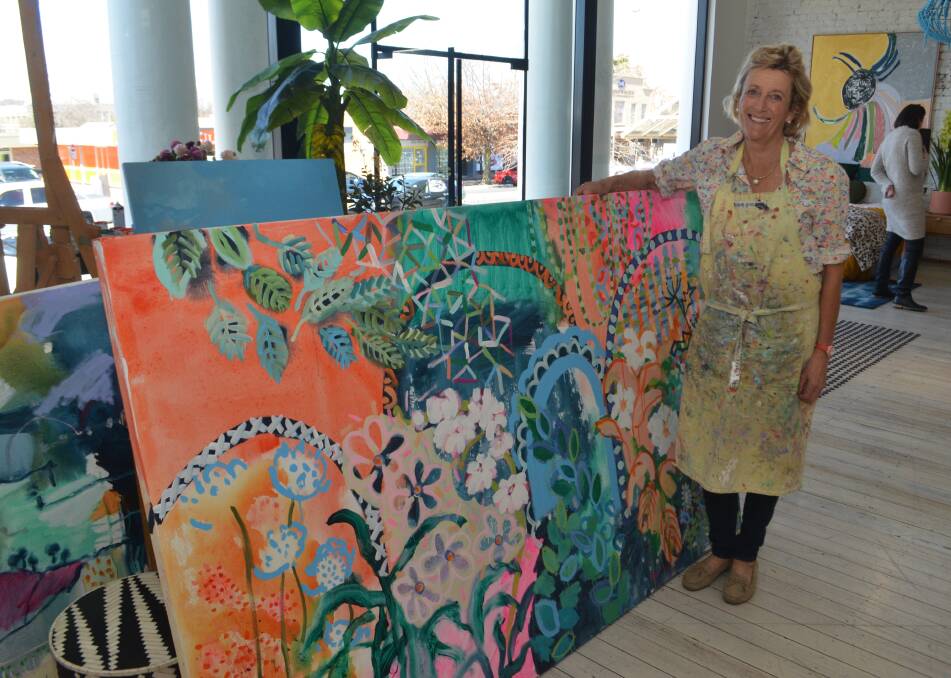 THRILLED: Kezz Brett with the painting she sold to help farmers in Narromine and Coonamble. 