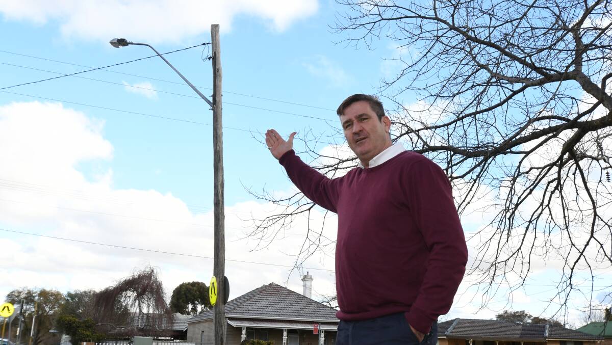 SWITCHED OFF: Nile Street resident David Radel points out the malfunctioning streetlight near his home. Photo: JUDE KEOGH 0705jklights2