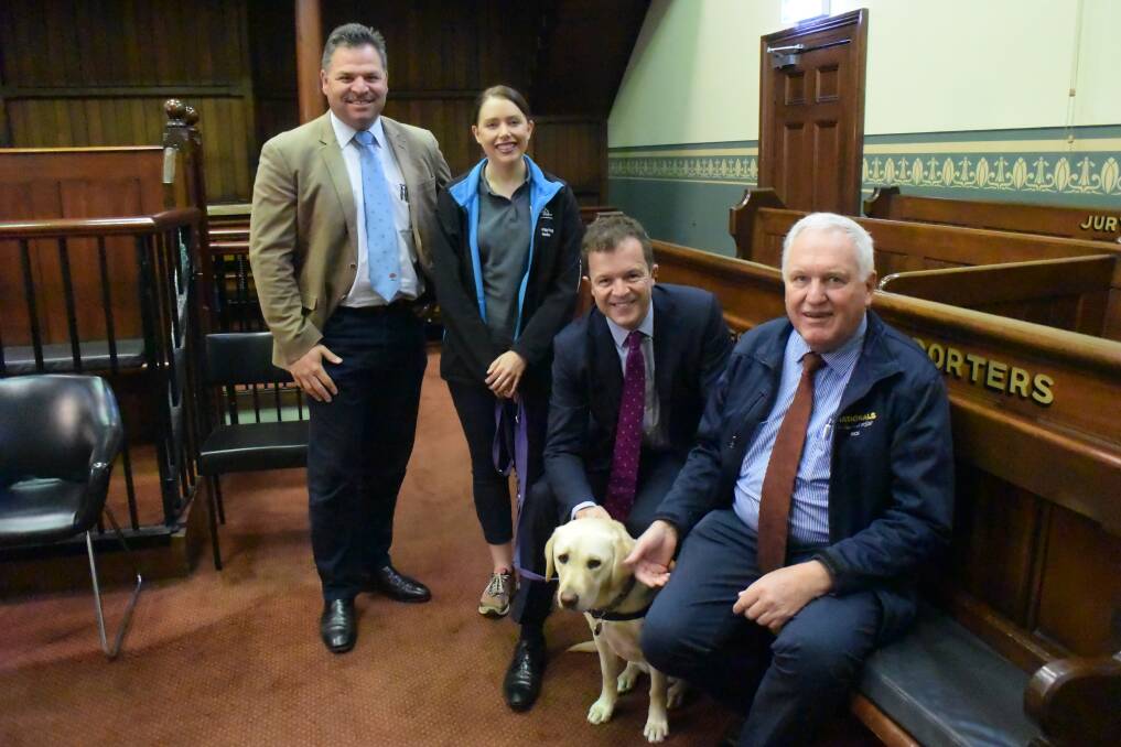 FURRY FRIEND: Ollie the labrador with Orange MP Phil Donato, Guide Dogs NSW/ACT handler Sam McGill, Attorney-General Mark Speakman and Western NSW parliamentary secretary Rick Colless. Photo: DANIELLE CETINSKI