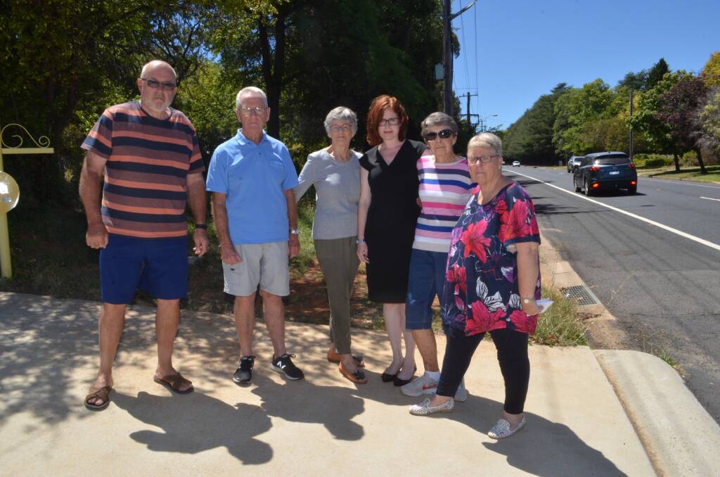IN THE DARK: Forbes Road residents Geoff Bocking, David and Helen Hartnett, Melanie Berry, Marg Murray and Lynn Bocking on their driveway, next door to the site.