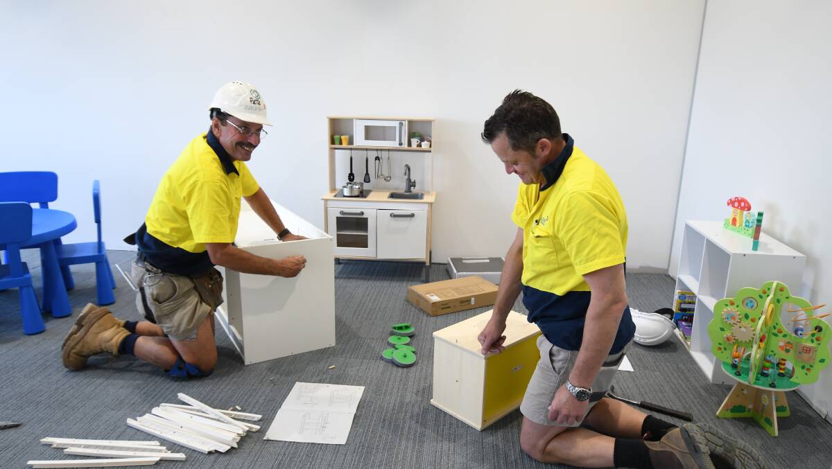 UNDER CONSTRUCTION: Peter Vagg and David Pye build furniture for the children's playroom in the waiting area. 