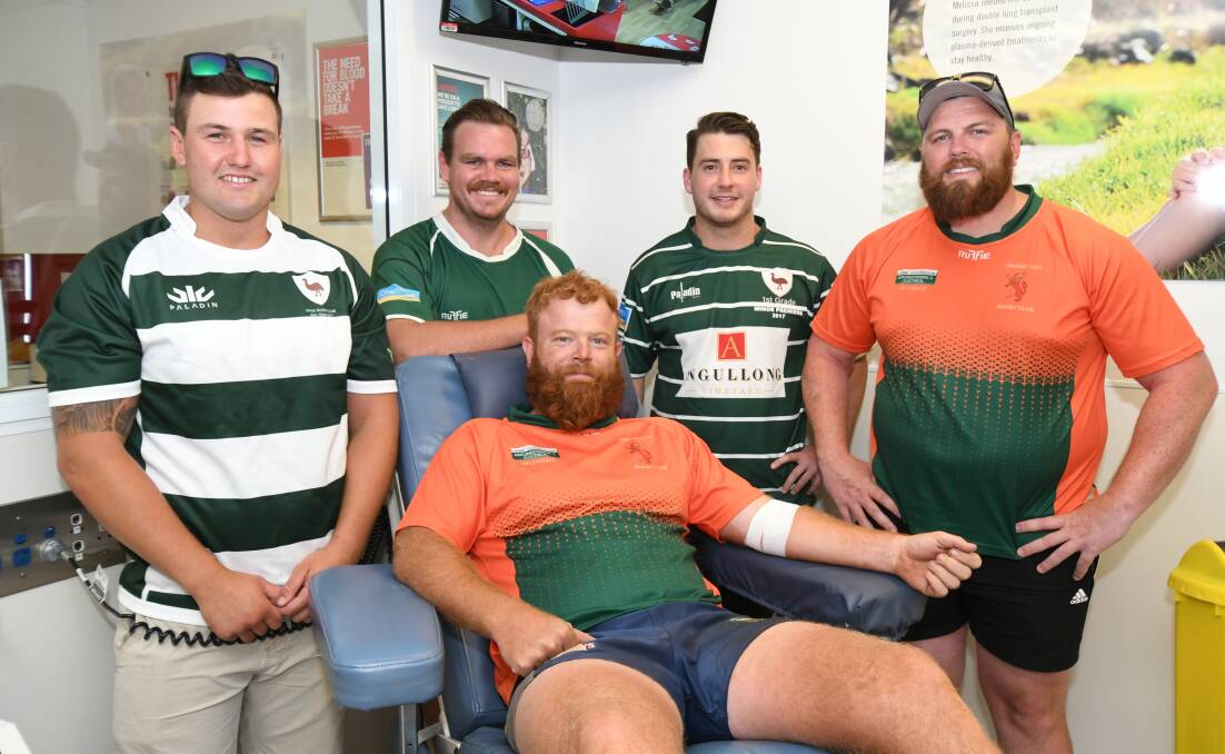 VALUABLE DROP: Orange City captain Will Ryan donates blood, supported by Emus Joel Urban, Matt Findlay and Harry Cummins and City's Paul Hepworth. Photo: JUDE KEOGH 1118jkblood1