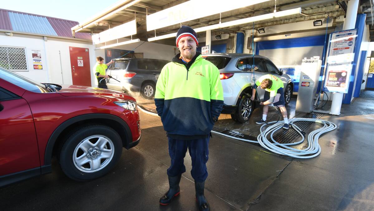HARD AT WORK: Pete's Car Wash manager Daniel Neill expects to take more business once level five water restrictions come into force. Photo: JUDE KEOGH