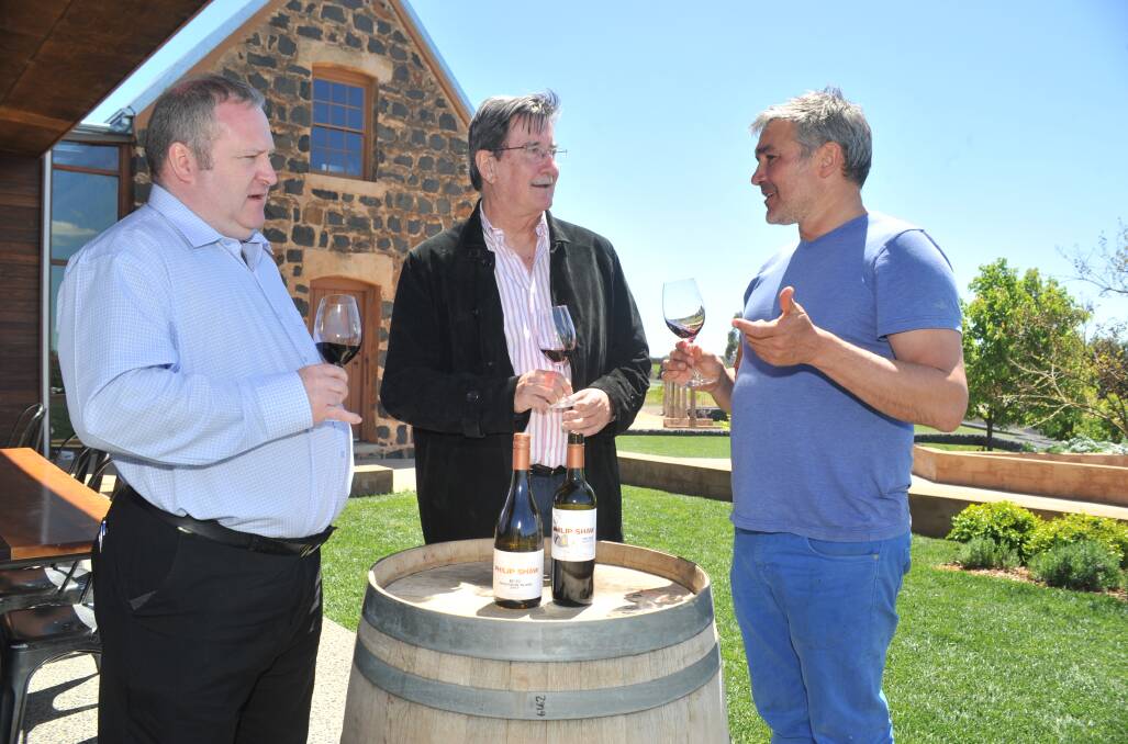 DROPPING IN: International Convention Centre Sydney cellar manager William Wilson, chief executive officer Geoff Donaghy and Philip Shaw Wines' Daniel Shaw. Photo: JUDE KEOGH 1013jnswwine1