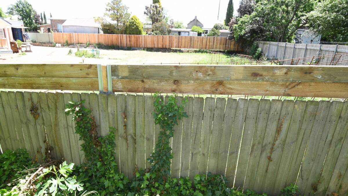 NOT A PALING FENCE: Two rows of boards were added to the old fence. Photo: JUDE KEOGH 1122jkfence1
