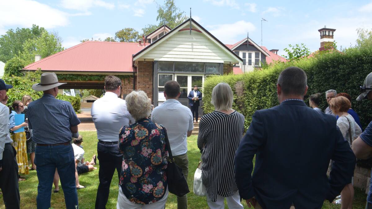 SOLD: Auctioneer Will Dean primed the crowd in the property's rear yard before bidding started. Photo: DANIELLE CETINSKI