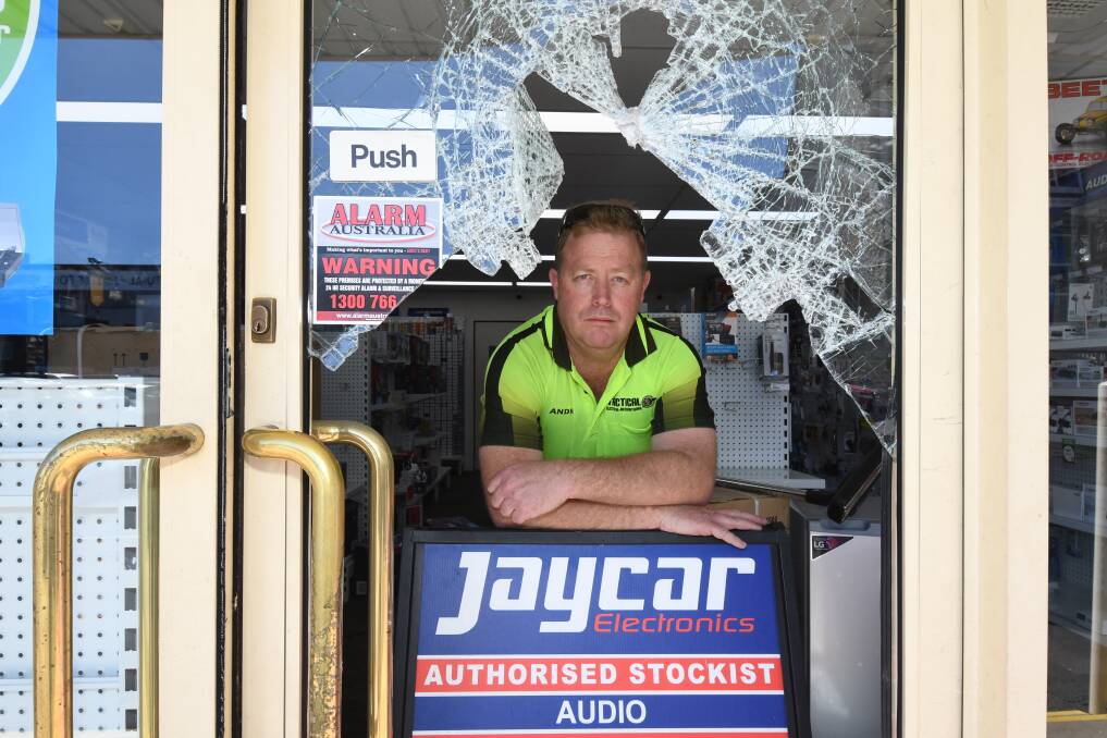 STOCK STOLEN: Tactical Electrical owner Andrew Bailey examines the damage caused to his shopfront on Monday morning. Photo: CARLA FREEDMAN 