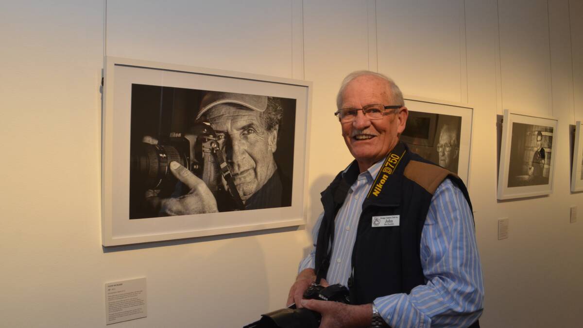 THROUGH THE LENS: John McNabb with his portrait of Alf Manciagli. Photo: DANIELLE CETINSKI 0909dccamera1