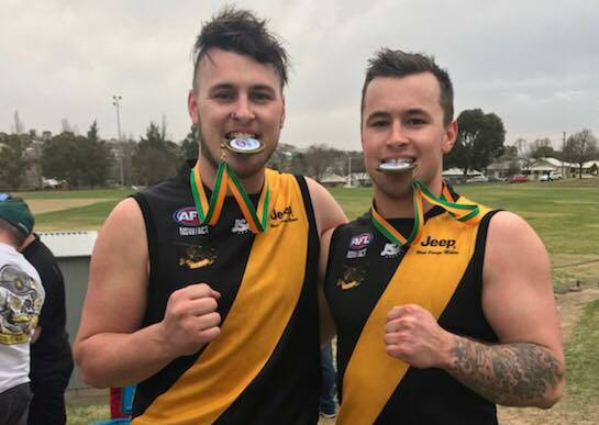 BROTHERS IN ARMS: Chris (left) and Michael Rothnie after their 2018 premiership win with the Orange Tigers.