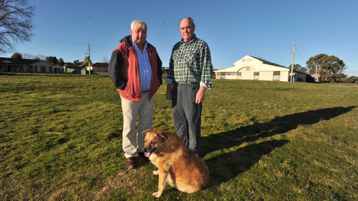 SHORT ON CASH: Orange Show Society president Peter Naylor (right) with former councillor Ron Gander where the old stables used to be. 