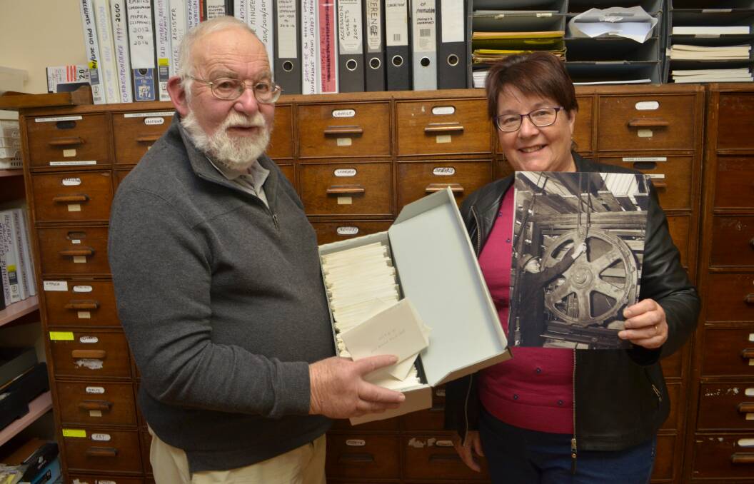 PRICELESS HISTORY: Orange and District Historical Society secretary Phil Stevenson and president Liz Edwards show off negatives and photographs in need of digitising. Photo: DANIELLE CETINSKI 0517dcphotos1