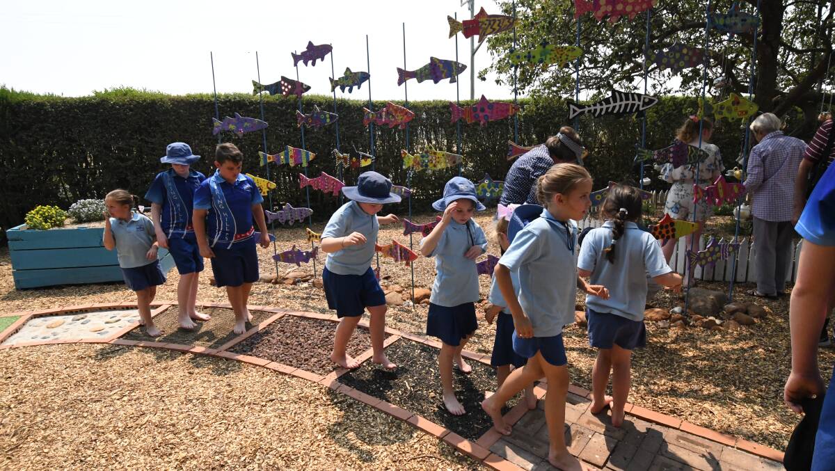 SENSORY DELIGHT: Spring Hill Public School students check out the multi-surface path through their new garden. Photo: JUDE KEOGH